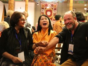 Three people smiling and laughing.